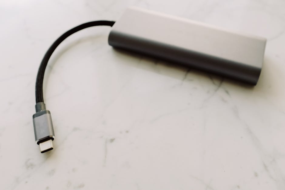 Close-up of a USB-C adapter on a marble surface, showcasing modern technology.