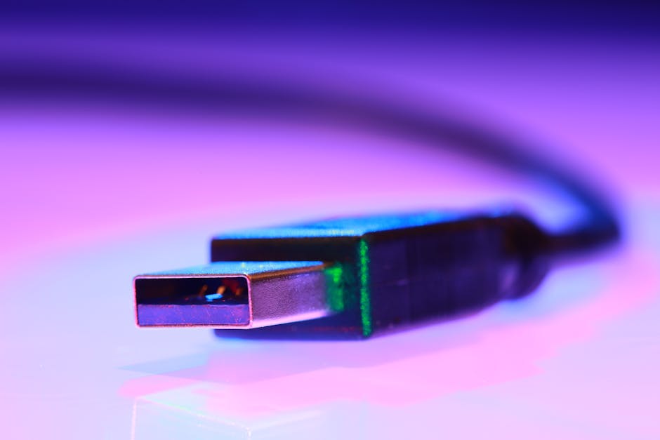 Vibrant close-up of a USB cable against a purple gradient background.