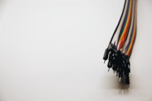 Close-up of colorful electronic jumper wires on a white background.