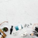 Flat lay of a marble desk featuring tech gadgets, stationery, and decor items, perfect for creatives.